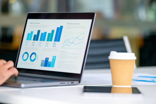 istock Close up of businessman using a laptop with graphs and charts on a laptop computer. 2160140672