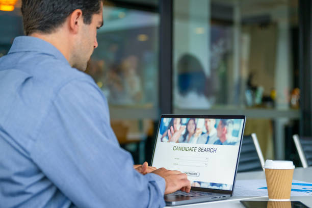 istock Businessman looking at recruitment website on a laptop computer. 2160140705
