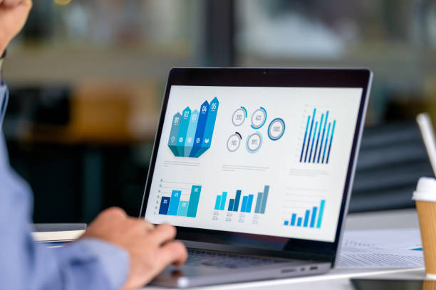 istock Close up of businessman using a laptop with graphs and charts on a laptop computer. 2160140805