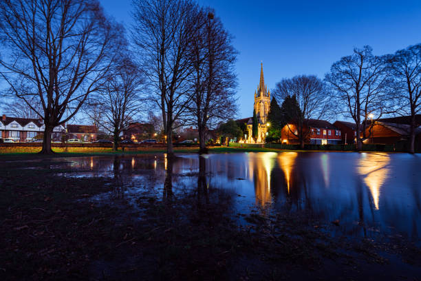 Marlow All Saints Church reflected in flood water amongst trees