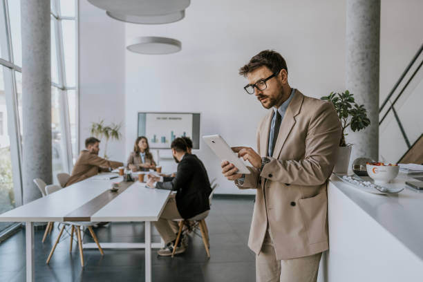 istock Businessman using tablet in modern office during meeting 2160143593