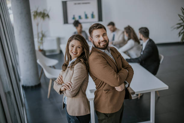istock Confident business professionals standing back to back in a modern office 2160143670