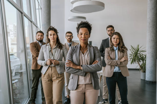 istock Business professionals standing confidently in a modern office building 2160143716