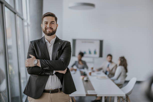istock Confident businessman standing in modern office meeting room 2160143738