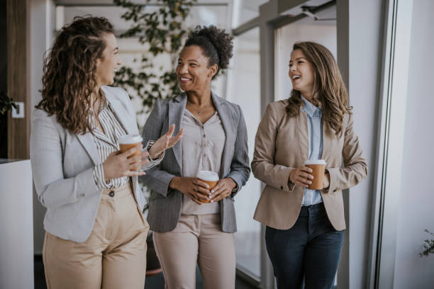 istock Three businesswomen chatting during break in modern office 2160144415