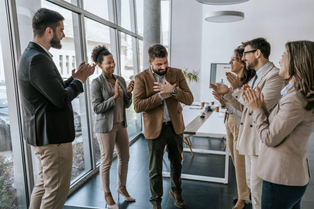 istock Business team applauding colleague in modern office 2160144483