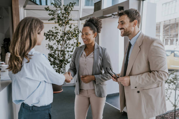 Business professionals shaking hands in a modern office lobby