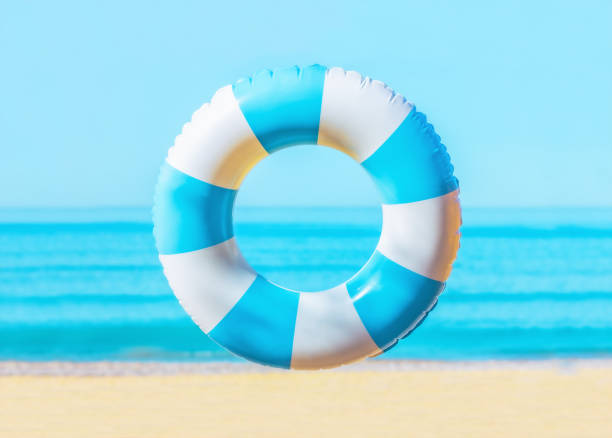 blue and white Inflatable ring on the sea beach, summer background, no people, copy space