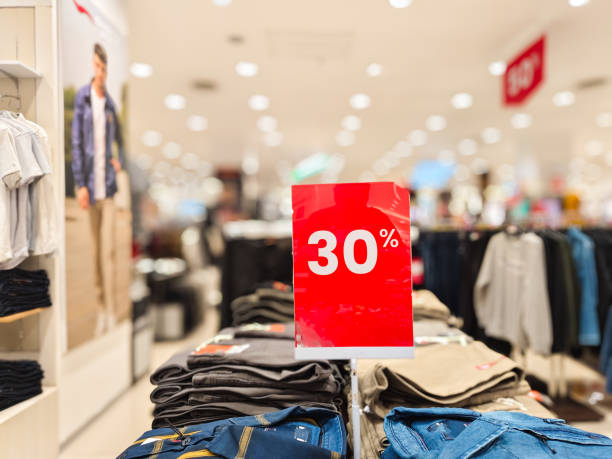 istock selective focus to red discount board with 30% writing. for discount templates for women's and men's clothing at the mall. soft focus 2160149494