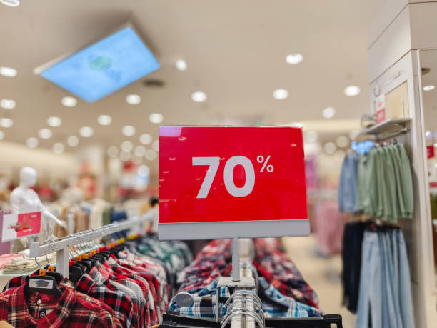 istock selective focus to red discount board with 70% writing. for discount templates for women's and men's clothing at the mall. soft focus 2160149500