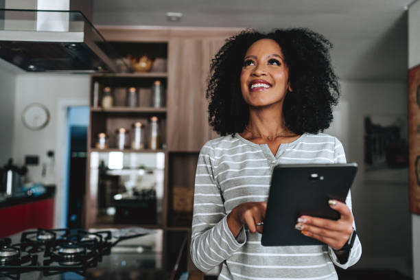 How EdgeProp Empowers Smarter Property Decisions in Malaysia woman controlling her smart home using an automated system - How EdgeProp Empowers Smarter Property Decisions in Malaysia