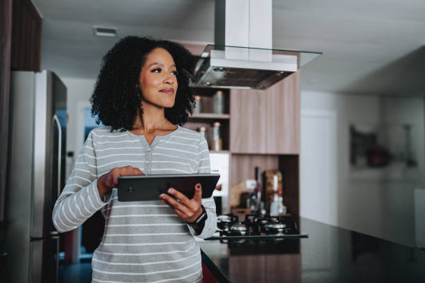 istock Woman controlling her smart home using an automated system 2160150633