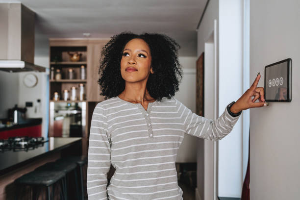 istock woman adjusting a smart home system using a digital tablet  AI 2160150720