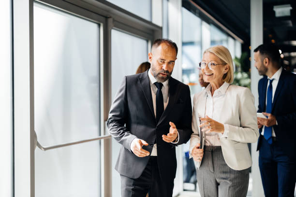 Business professionals discussing in office corridor
