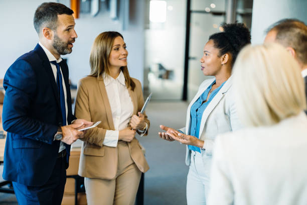 istock Colleagues discussing in the corridor 2160152675