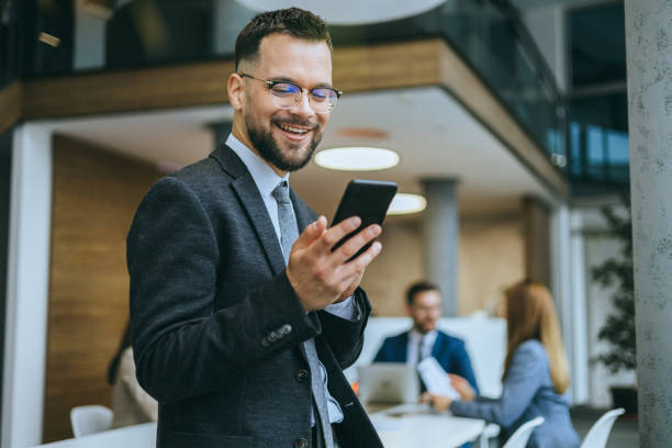 Engaged employee with a phone in modern office