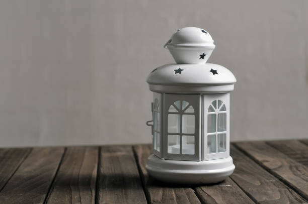decorative lantern and white lantern on wooden background