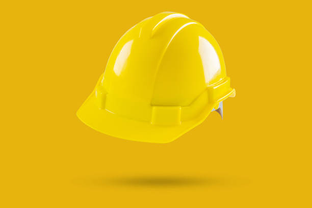 istock Safety construction helmet on yellow background 2160153058