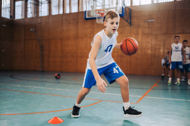 istock Young athlete dribbling basketball 2160153332