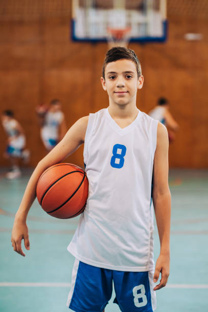 istock Focused kid in basketball uniform 2160153334