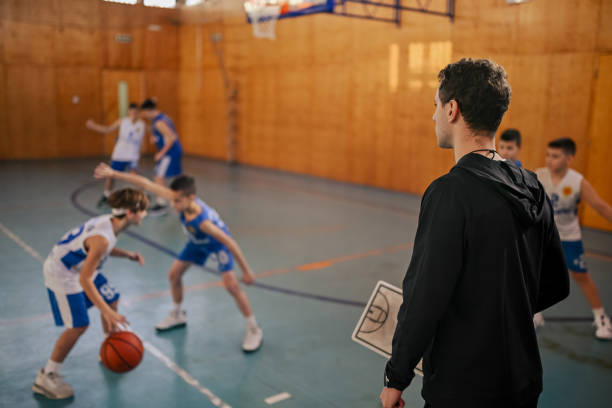 istock Coach watching young players in a game 2160153338