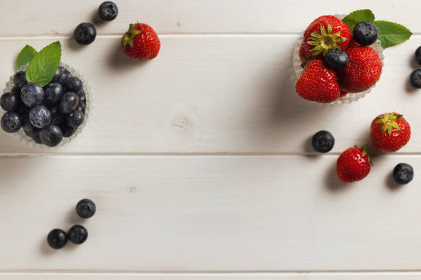Fresh Fruit Bowl containing strawberries, blueberries and blackberries.  Fresh colorful vibrant fruit in bowl.  Looking down.  Studio light.