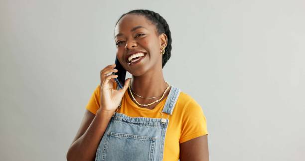 istock Woman, phone call and talking in studio with smartphone, online communication and conversation on mobile app. Connection, tech and listening for information, network discussion and background 2160159869