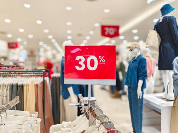 istock selective focus to red discount board with 30% writing. for discount templates for women's and men's clothing at the mall. soft focus 2160162468