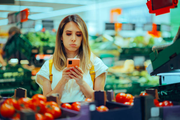 istock Forgetful Supermarket Client Checking her Digital Shopping List 2160170143