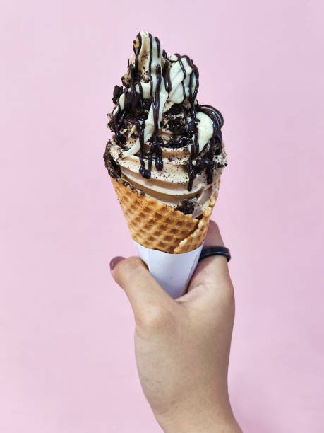 istock Delicious Vanilla Ice Cream Cone with Chocolate Syrup 2160170798