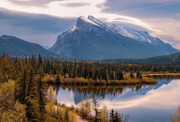 istock Cloudy Sunlit Sky Glowing Over Mountains At Vermilion Lakes 2160172734