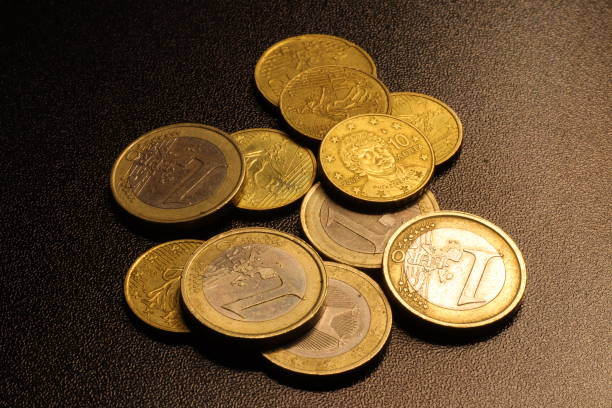 Large group of digital coins rising step by step on black background. The earnings of new billionaires have been increasing rapidly in recent years.