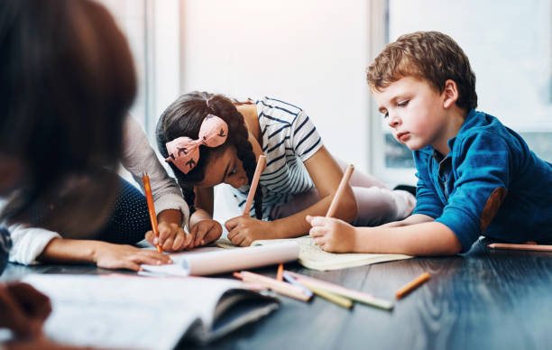 istock Drawing, color and children on floor with paper for creative lesson, learning and child development at kindergarten. School, youth academy and kids with crayons for education, creativity and writing 2160176414