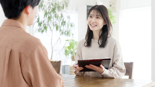 istock Asian woman interviewing a man 2160182346