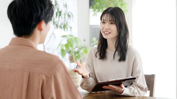 istock Asian woman interviewing a man 2160182362