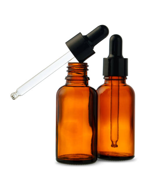 istock Two Amber Glass Dropper Bottles With One Dropper Removed on White Background 2160182587