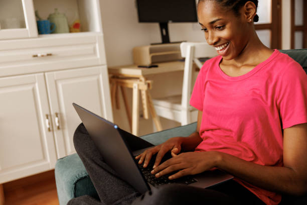 istock Young woman using laptop at home 2160186595