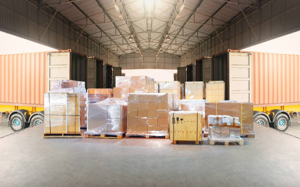 istock Bulk pallets of packaging boxes being loaded onto a container truck. distribution warehouse Container transport, supply chain, parcel delivery. Freight truck, logistics, transportation. 2160190102
