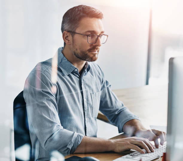 istock Office, computer and business man typing at desk for project proposal, update report or feedback. Admin, human resources and employee with keyboard for planning, agenda or review plans in workplace 2160190418