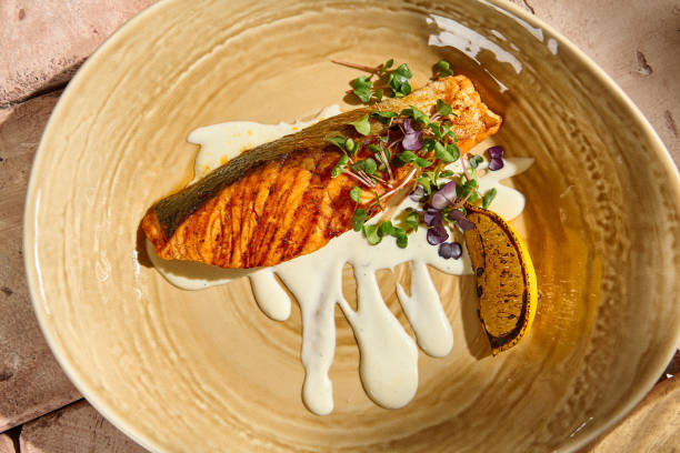 istock Authentic Salmon Steak with Creamy Sauce in Sunlit Still Life Setting 2160190550