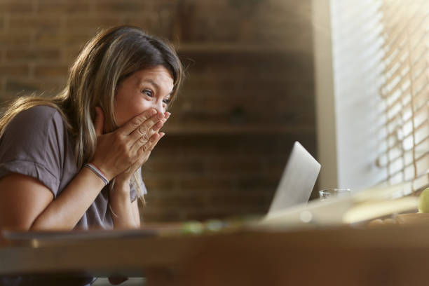 istock Surprised woman reading an e-mail on laptop at home. 2160190912