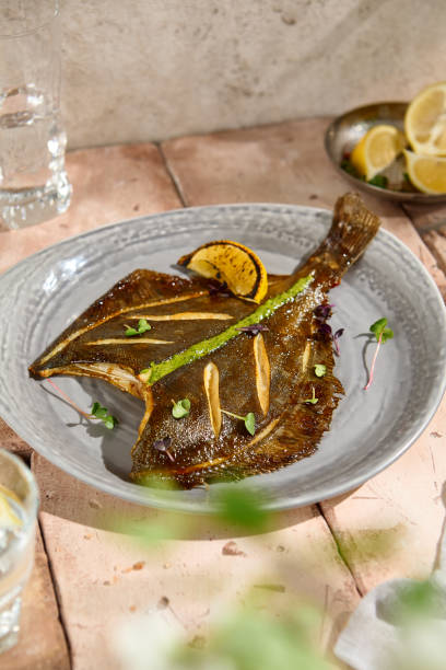 istock Authentic Fried Flounder with Lemon Wedge in Natural Sunlit Still Life Setting 2160192750