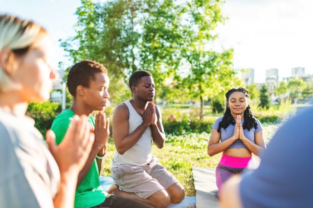 istock Yoga class outdoors. Lotus position 2160193177
