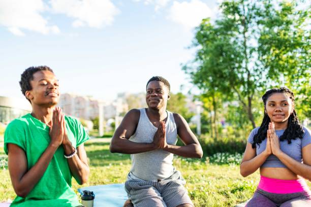 istock Yoga class outdoors. Lotus position 2160193179