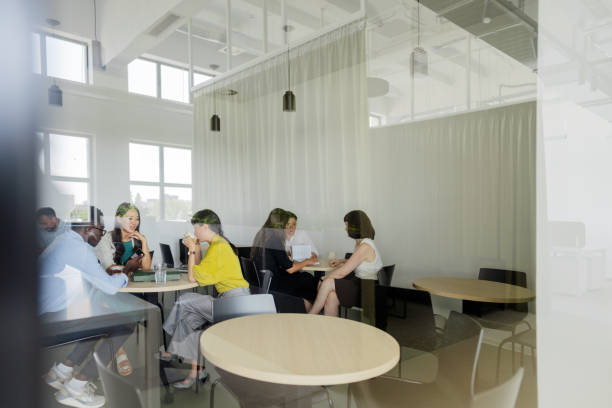 istock Colleagues taking a break in the office cafeteria 2160193274