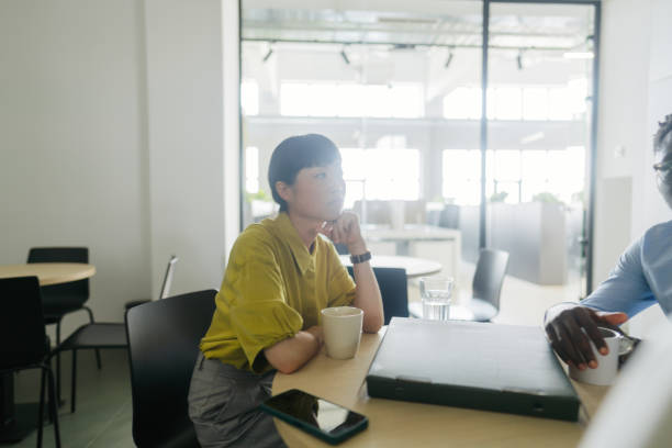 istock Woman's having a coffee break in the office cafeteria 2160193275