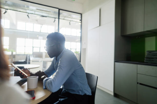 istock Man's having a coffee break in the office cafeteria 2160193284