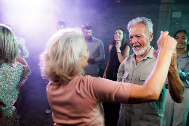istock Happy senior couple having fun while dancing in a disco. 2160197954