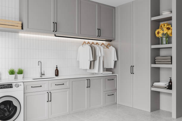 istock Grey home laundry interior with washing machine and sink, shelf with decoration 2160198617