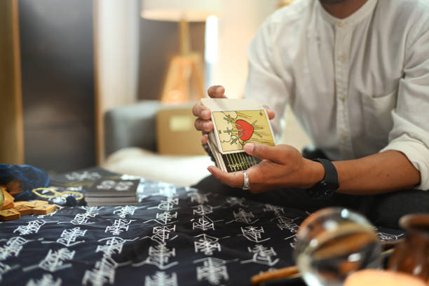 istock Fortune teller hands shuffling deck of tarot cards. Forecasting and divination concept 2160199242